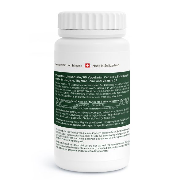 Oregano-Vida_v5.0-Back Eine weisse Flasche "Made in Switzerland" mit grünem Etikett enthält Oregano Vida vegetarische Kapseln mit Oregano, Thymian, Zink und Vitamin D3. Die Produktinformation erscheint sowohl in Deutsch als auch in Englisch.